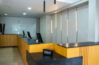 an office cubicle with desks and a sign that reads autism at Hilton San Salvador in San Salvador