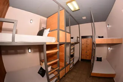 a small room with a bunk bed and a staircase at Hostal Sole in Santa Ana