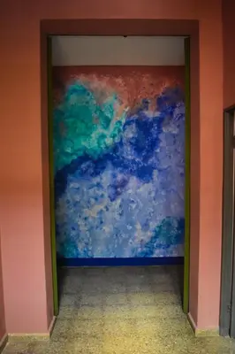 a painting on a wall in a room at Hostal Sole in Santa Ana