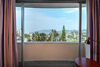a room with a large window with a view at Sheraton Presidente San Salvador in San Salvador