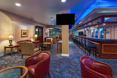 a hotel lobby with a bar and a waiting room at Sheraton Presidente San Salvador in San Salvador