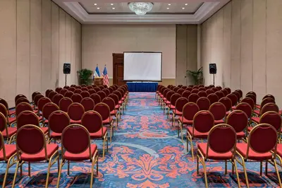 a conference room with chairs and a screen at Sheraton Presidente San Salvador in San Salvador