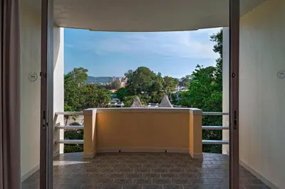 a balcony with a view of a bath tub at Sheraton Presidente San Salvador in San Salvador
