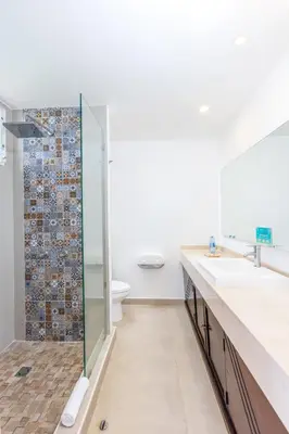a bathroom with two sinks and a shower at Royal Decameron Salinitas - All Inclusive in Los Cóbanos