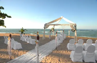 a wedding ceremony on the beach with white chairs at Royal Decameron Salinitas - All Inclusive in Los Cóbanos