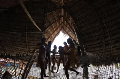 a group of people walking through a thatched hut at Mizata By Antiresort in Santa María Mizata