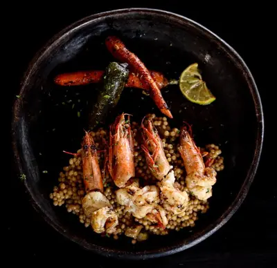 a bowl of food with shrimp and vegetables and a lime at Mizata By Antiresort in Santa María Mizata