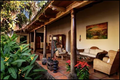 a living room with a couch and some plants at Los Almendros de San Lorenzo in Suchitoto