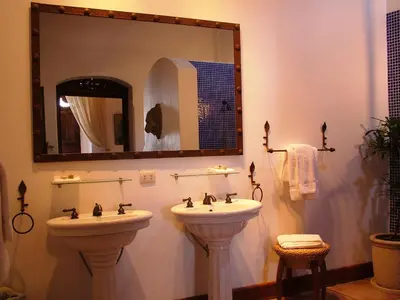 a bathroom with two sinks and a mirror at Los Almendros de San Lorenzo in Suchitoto
