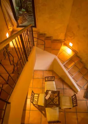 an overhead view of a staircase with chairs and tables at Los Almendros de San Lorenzo in Suchitoto