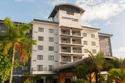 a hotel with a tower on top of it at Courtyard by Marriott San Salvador in San Salvador