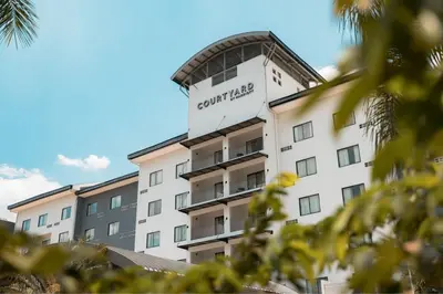 a building with a sign that reads courtyard hotel at Courtyard by Marriott San Salvador in San Salvador
