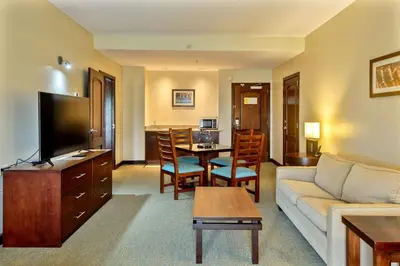a living room with a couch and a table at Courtyard by Marriott San Salvador in San Salvador