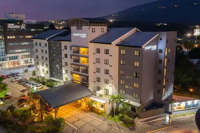 an overhead view of a building in a city at night at Courtyard by Marriott San Salvador in San Salvador