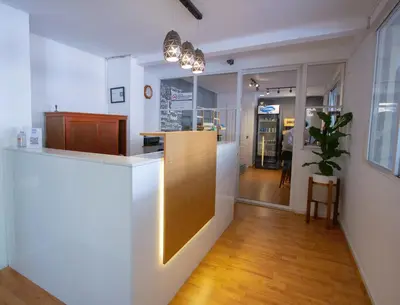 a kitchen with white walls and a wooden counter top at Hotel Villa Serena San Benito in San Salvador