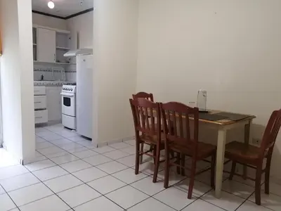 a kitchen with a table and chairs and a stove at Hotel Villa Serena San Benito in San Salvador