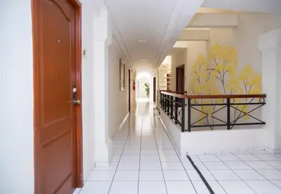 a hallway with a door and a tile floor at Hotel Villa Serena San Benito in San Salvador