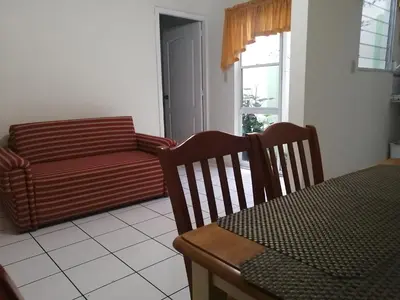 a living room with a couch and a table at Hotel Villa Serena San Benito in San Salvador
