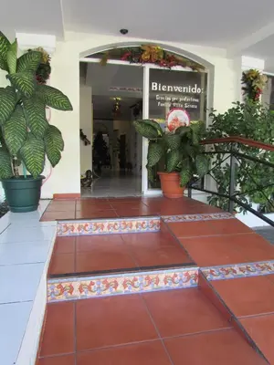 a lobby of a hotel with potted plants at Hotel Villa Serena San Benito in San Salvador