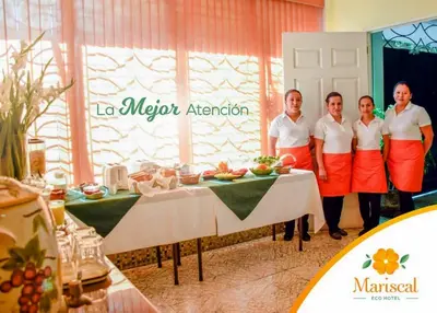 a group of people standing in front of a table at Eco Hotel Mariscal in San Salvador