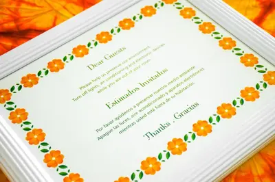 a white framed diploma with orange flowers on it at Eco Hotel Mariscal in San Salvador