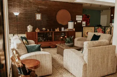a living room with two chairs and a table at Eco Hotel Mariscal in San Salvador