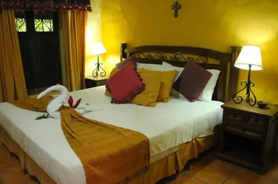 a bedroom with a bed with a swan on it at La Posada de Suchitlan in Suchitoto