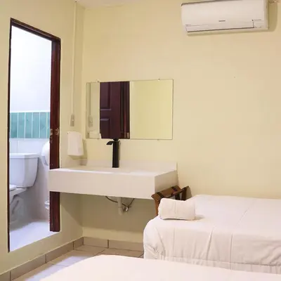 a bathroom with a sink and a mirror at Morrison Hotel San Salvador in San Salvador