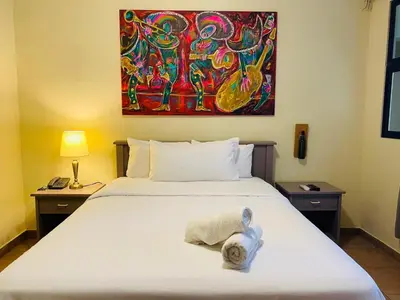 a bedroom with a bed with a stuffed animal on it at Morrison Hotel San Salvador in San Salvador