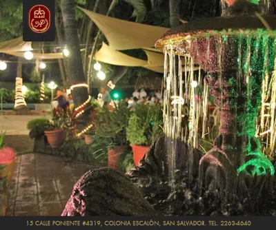 a water fountain in a room with plants at Hotel Mediterraneo Plaza in San Salvador
