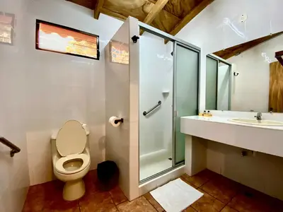 a bathroom with a shower and a toilet and a sink at El Tejado in Suchitoto