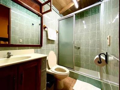 a bathroom with a toilet and a glass shower at El Tejado in Suchitoto