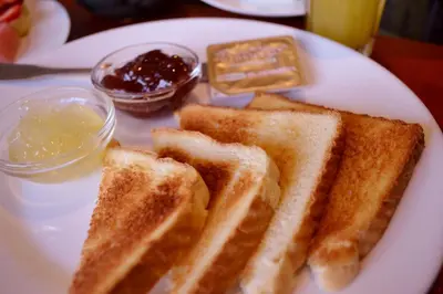 a plate of toast with butter and jam on it at Hotel Villa Florencia Zona Rosa in San Salvador