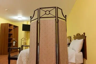 a bedroom with a canopy bed in a room at Hotel Villa Terra in San Salvador