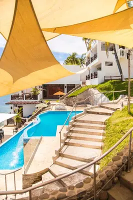 a resort with a swimming pool and stairs at Hotel Los Farallones in La Libertad