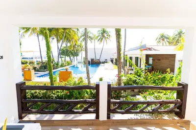 a bench on a porch with a view of a pool at Hotel Los Farallones in La Libertad