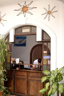 a man standing at a counter in a kitchen at Hotel Villa Florencia Centro Histórico in San Salvador