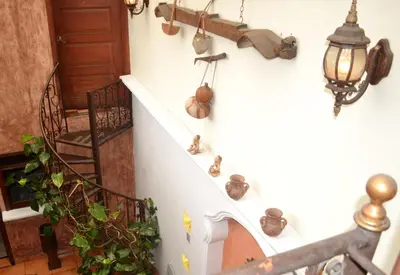 a staircase with pots and vases on the wall at Hotel Villa Florencia Centro Histórico in San Salvador