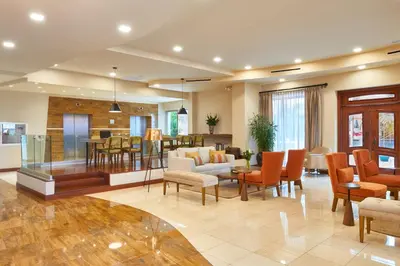 a living room with a dining room and a kitchen at Suites las Palmas, Hotel & Apartments. in San Salvador