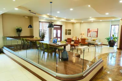 a living room with a table and chairs and a dining room at Suites las Palmas, Hotel & Apartments. in San Salvador