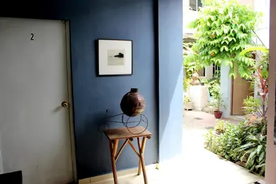 a vase sitting on a table next to a door at Ximenas Guest House in San Salvador