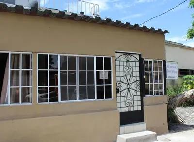 a building with a door with a stained glass window at Ximenas Guest House in San Salvador