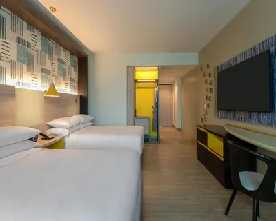 a hotel room with two beds and a flat screen tv at Hyatt Centric San Salvador in San Salvador