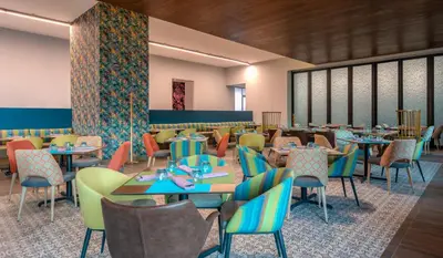 a rendering of a restaurant with tables and chairs at Hyatt Centric San Salvador in San Salvador