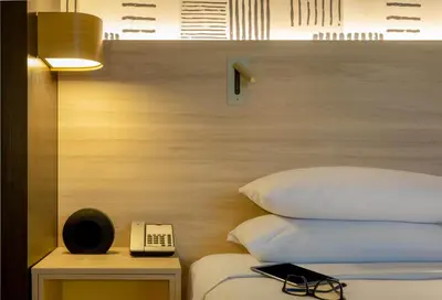 a bedroom with a bed with a phone next to it at Hyatt Centric San Salvador in San Salvador