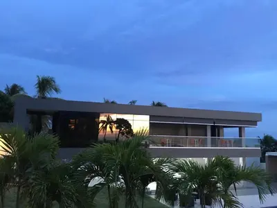 a large house with palm trees in front of it at Acantilados in La Libertad