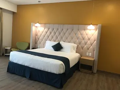 a bedroom with a large bed with a large headboard at Acantilados in La Libertad