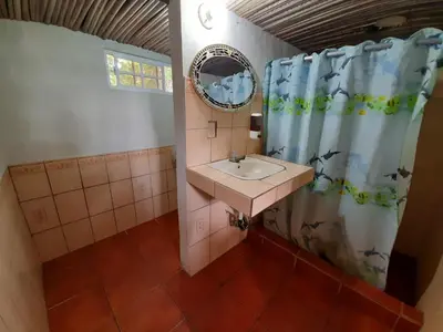 a bathroom with a sink and a mirror at Capricho Beach House in El Zapote