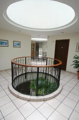 a large room with a fountain in the middle of a building at Hotel Berlin in San Salvador