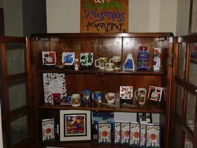a shelf filled with different types of mugs at Hotel San Jose Hostal in San Salvador